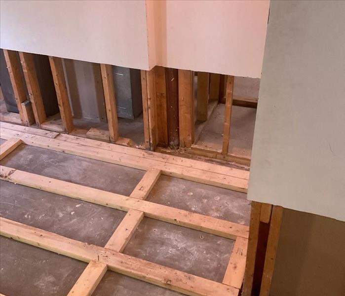 Visible floor and wall framing over a concrete foundation