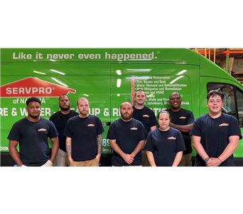 group photo of SERVPRO team in front of green box truck