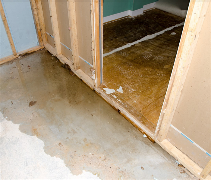 a flooded room with water leaving through the doorway